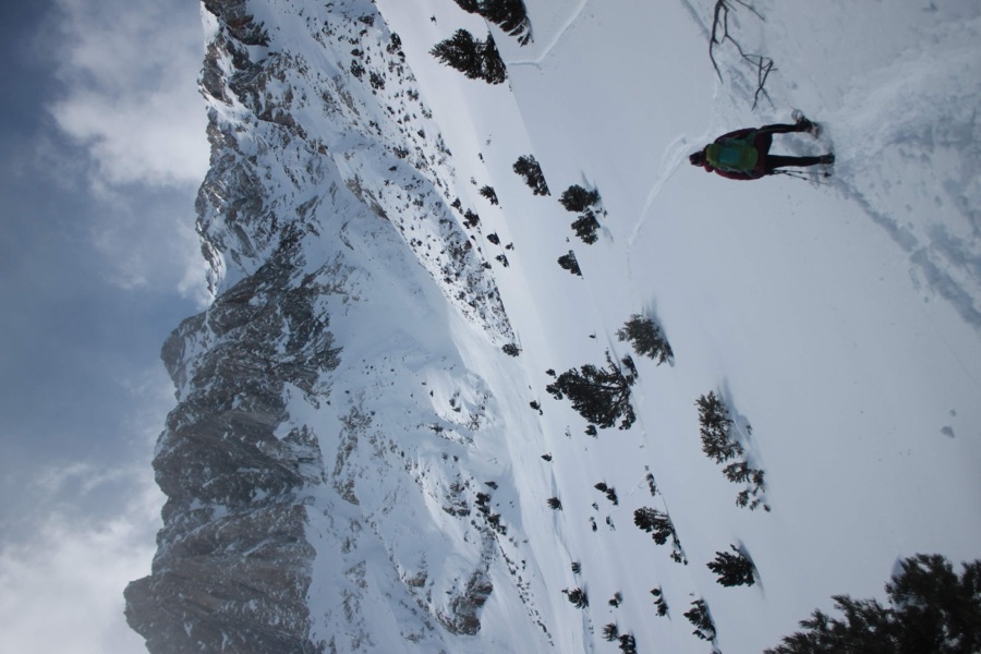 Sam snowshoeing up a snowy mountain valley